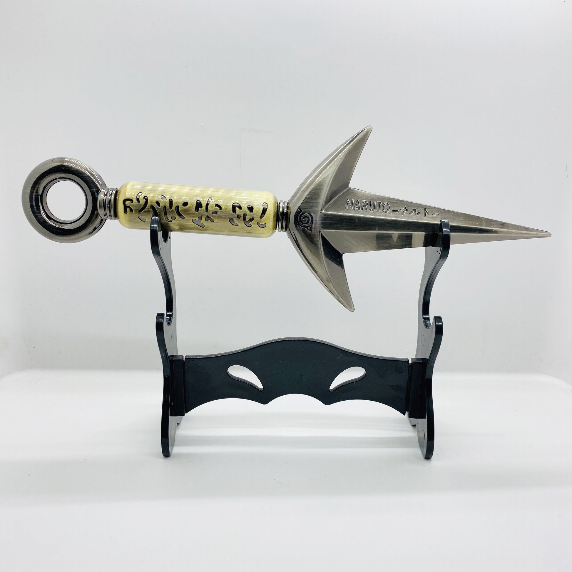 Decorative bow arrow head with gold and silver design on a stand against a white background