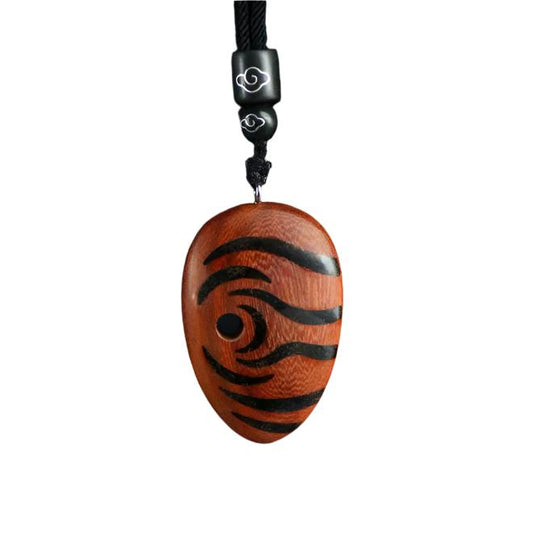Wooden pendant with black spiral design on a white background