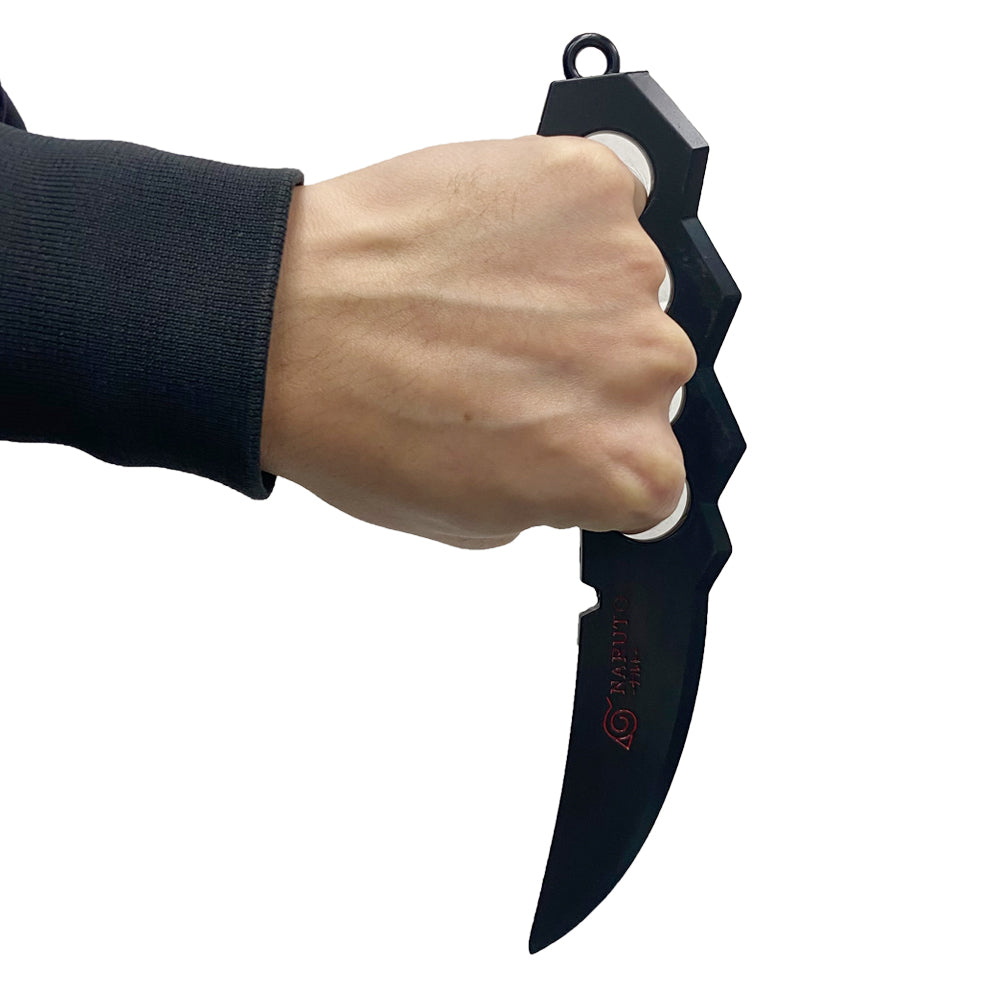 Hand holding a black knife with a white background