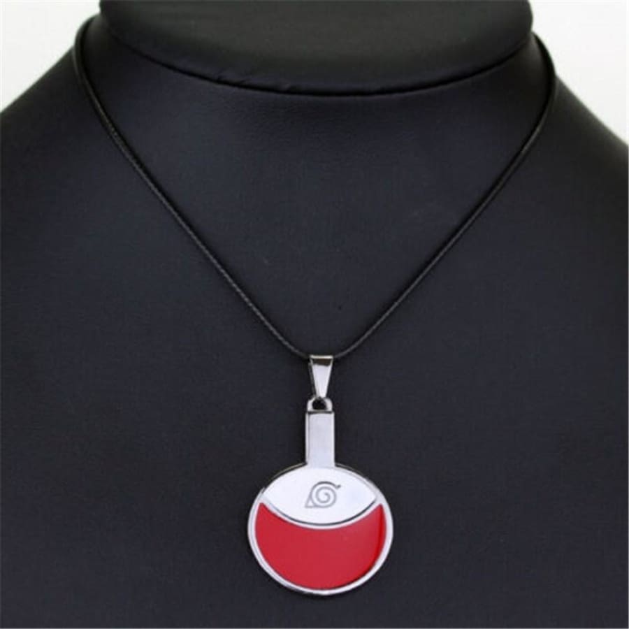 Necklace with a red and silver pendant on a black mannequin