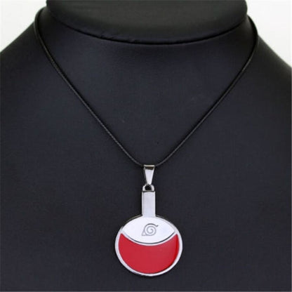 Necklace with a red and silver pendant on a black mannequin