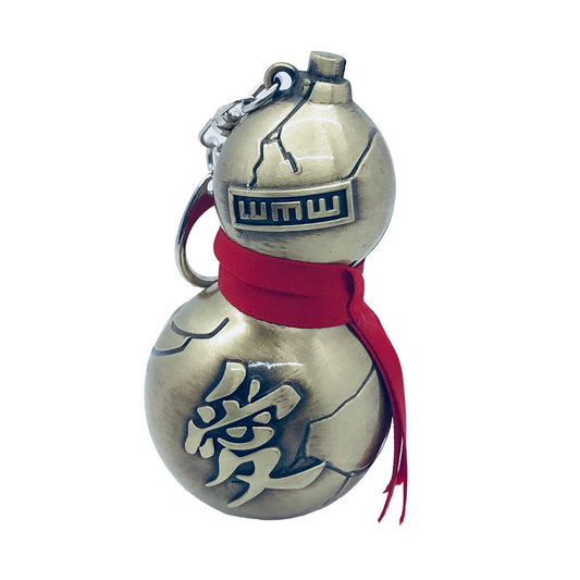 Decorative keychain with a red ribbon and metallic design on a white background