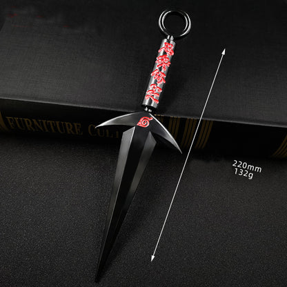 Black and red decorative object on a dark surface