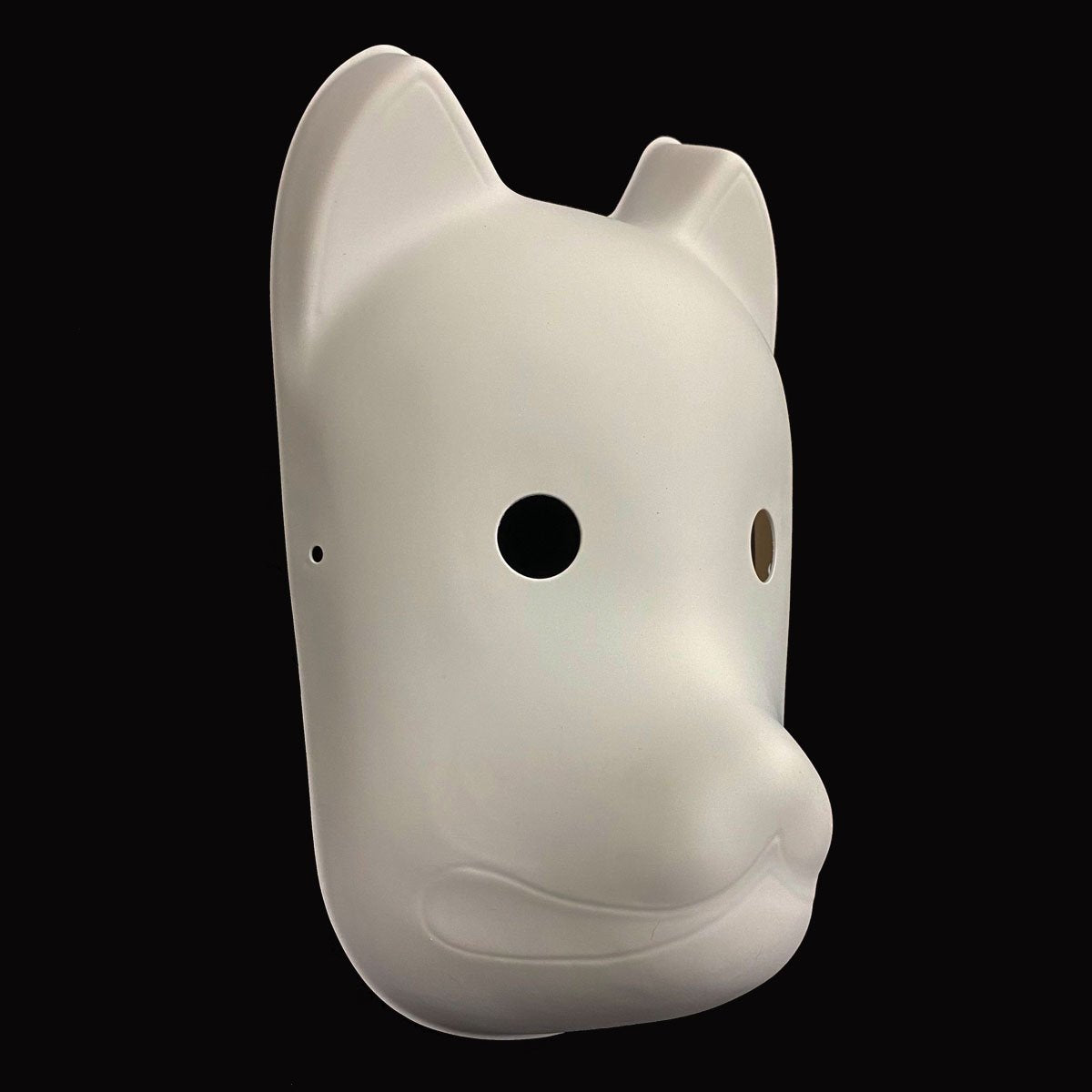 White dog-shaped mask on a black background